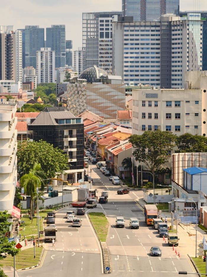 A vibrant city scene with high-rise buildings and traffic on the streets, capturing the urban lifestyle.